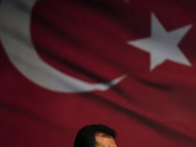 Istanbul Mayor Ekrem Imamoglu looks towards his supporters while they gather in front of the municipal building in Istanbul, Thursday, Dec. 15, 2022. Thousands of people gathered outside the Istanbul municipal building for a second day on Thursday to denounce a legal verdict that could lead to the city's popular mayor being ousted from office and barred from running in elections next year. (AP Photo/Khalil Hamra)