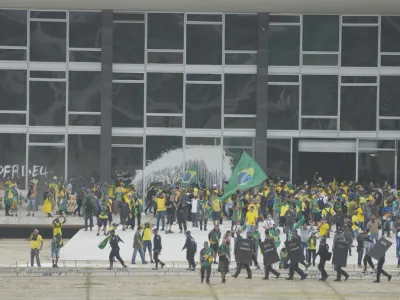 Protesters, supporters of Brazil's former President Jair Bolsonaro, storm the Supreme Court building in Brasilia, Brazil, Sunday, Jan. 8, 2023. The protesters who refuse to accept Bolsonaro&acute;s election defeat stormed Congress, the Supreme Court and presidential palace in the capital, a week after the inauguration of his rival, President Luiz Inacio Lula da Silva. (AP Photo/Eraldo Peres)