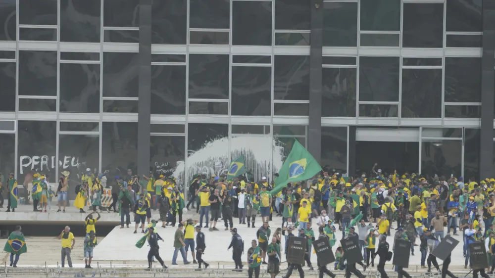 Protesters, supporters of Brazil's former President Jair Bolsonaro, storm the Supreme Court building in Brasilia, Brazil, Sunday, Jan. 8, 2023. The protesters who refuse to accept Bolsonaro&acute;s election defeat stormed Congress, the Supreme Court and presidential palace in the capital, a week after the inauguration of his rival, President Luiz Inacio Lula da Silva. (AP Photo/Eraldo Peres)