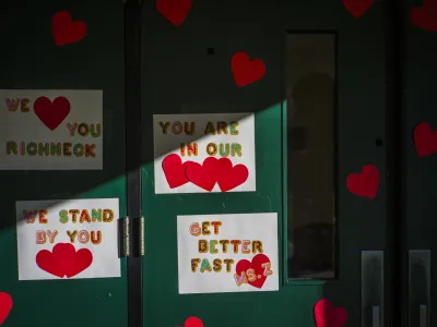 Messages of support for teacher Abby Zwerner, who was shot by a 6 year old student, grace the front door of Richneck Elementary School Newport News, Va. on Monday Jan. 9, 2023. The Virginia teacher who authorities say was shot by a 6-year-old student is known as a hard-working educator who's devoted to her students and enthusiastic about the profession that runs in her family. (AP Photo/John C. Clark)