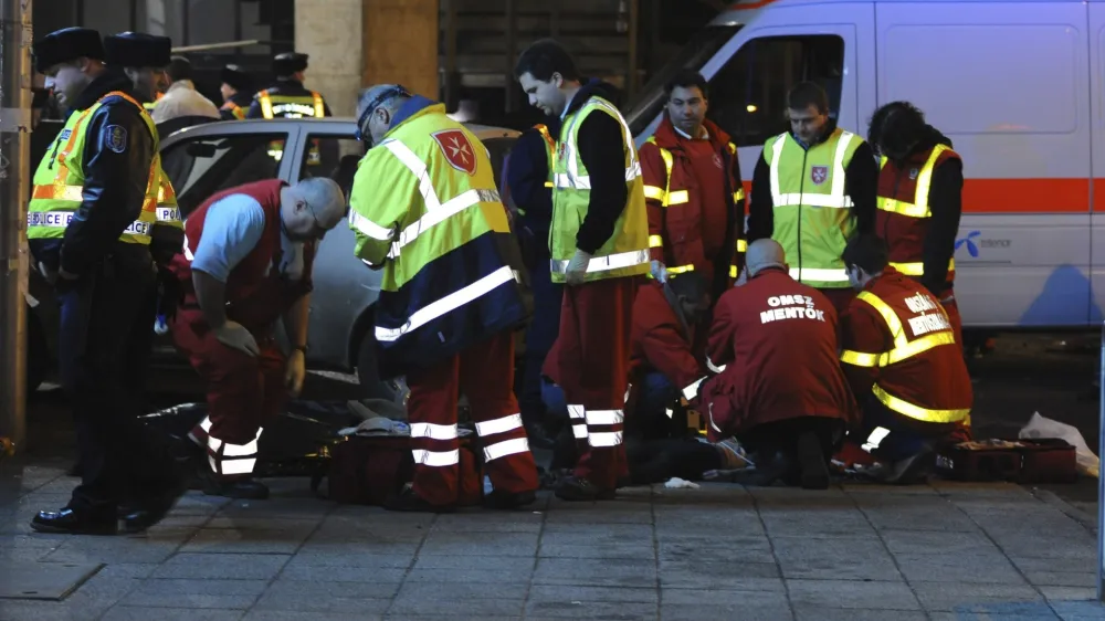 Ambulance personnel and police work outside West Balkan night club in Budapest, Hungary, Sunday, Jan. 16, 2011, in the early hours, after three girls died in a stampede. Budapest police spokeswoman Katalin Fanni Horvath says panic caused thousands of people to be caught up in the stampede and the victims may have been trampled by the rushing crowd. (AP Photo/MTI, Peter Lakatos)