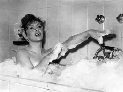 Italian actress Gina Lollobrigida takes a bubble bath in a scene of her new film called "Anna from Brooklyn", being shot at Rome's, Italy, Cinecitta studios, December 5, 1957. "Lollo" expects her first baby any day now. (AP Photo/Walter Attenni)
