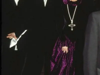 Diana, Princess Of Wales, arrives at a charity gala wearing a gold and amethyst crucifix in 1987