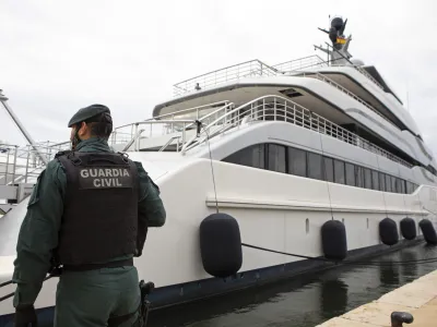 FILE - A Civil Guard stands by the yacht called Tango in Palma de Mallorca, Spain, April 4, 2022. Two businessmen have been charged with trying to conceal a sanctioned Russian oligarch's ownership of the luxury yacht seized in Spain last year by the U.S. government, the Justice Department said Friday, Jan. 20, 2023. (AP Photo/Francisco Ubilla, File)