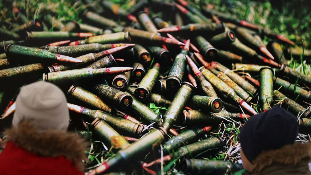 Children look at a picture taken in April 2022, as former British Prime Minister Boris Johnson visits the Church of Sviatoho Apostola Andriia Pervozvannoho (St. Apostle Andrew the First-Called) in Bucha, Kyivs'ka oblast, amid Russia's invasion of Ukraine, in Bucha, Ukraine January 22, 2023. REUTERS/Nacho Doce NO RESALES. NO ARCHIVES