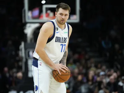 Dallas Mavericks guard Luka Doncic (77) looks to pass against the Phoenix Suns during the first half of an NBA basketball game, Thursday, Jan. 26, 2023, in Phoenix. (AP Photo/Matt York)