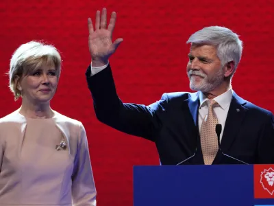 Czech Republic's President elect Petr Pavel with his wife Eva greets his supporters after announcement of the preliminary results of the presidential runoff in Prague, Czech Republic, Saturday, Jan. 28, 2023. (AP Photo/Petr David Josek)