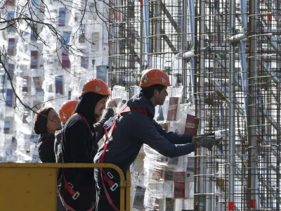 Workers hang books wrapped in plastic on the steel construction frame for the documenta art work "The Parthenon of Books' in Kassel, Germany, 24 April 2017. The reconstruction of the Parthenon temple of the Argentinian artist Marta Minujin is one of the largest projects of the Documenta. The Documenta will take place in Kassel from the 10th of June to the 17th of September 2017. Photo by: Swen Pf'rtner/picture-alliance/dpa/AP Images