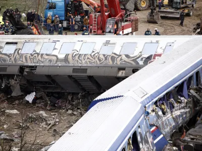 Debris of trains lie on the rail lines after a collision in Tempe, about 376 kilometres (235 miles) north of Athens, near Larissa city, Greece, Wednesday, March 1, 2023. A passenger train carrying hundreds of people, including many university students returning home from holiday, collided at high speed with an oncoming freight train before midnight on Tuesday. (AP Photo/Giannis Papanikos)