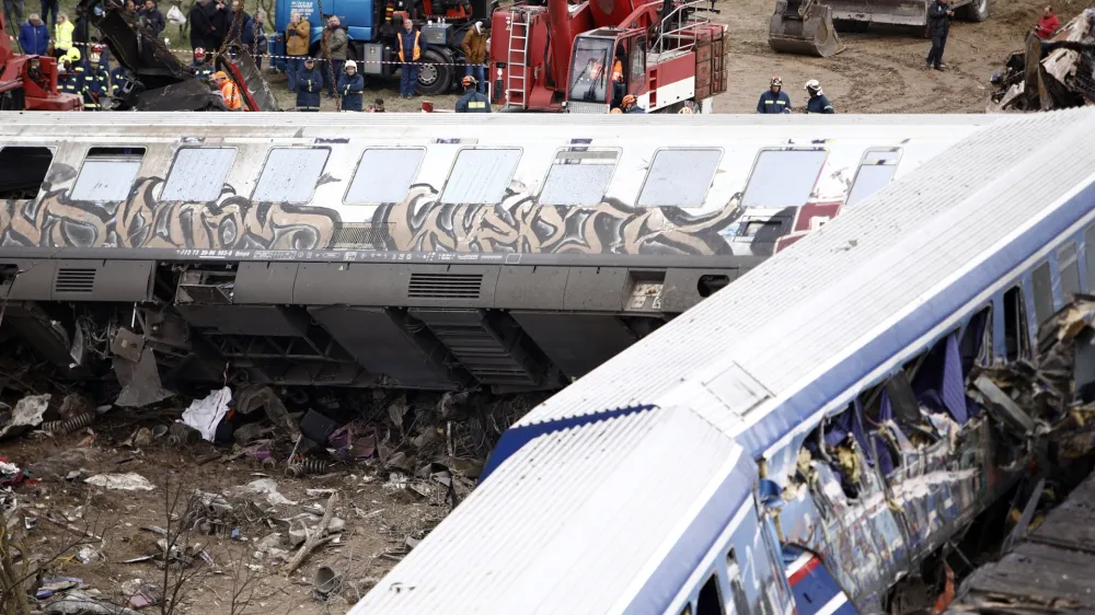 Debris of trains lie on the rail lines after a collision in Tempe, about 376 kilometres (235 miles) north of Athens, near Larissa city, Greece, Wednesday, March 1, 2023. A passenger train carrying hundreds of people, including many university students returning home from holiday, collided at high speed with an oncoming freight train before midnight on Tuesday. (AP Photo/Giannis Papanikos)