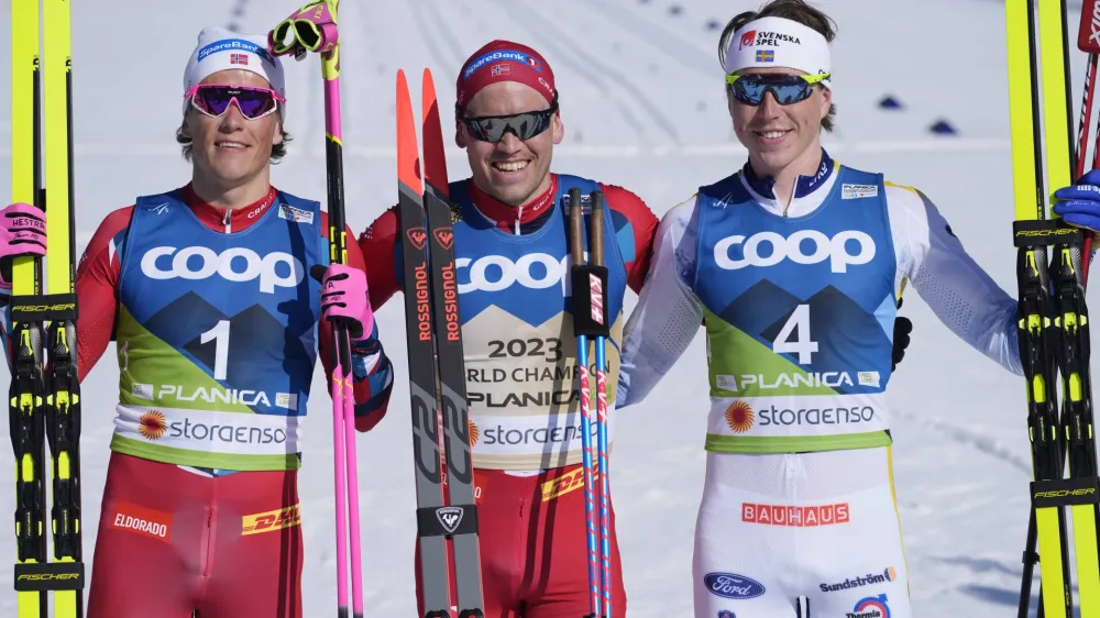 Winner Norway's Paal Golberg, center, poses besides second placed Norway's Johannes Hoesflot Klaebo, left, and third placed Sweden's William Poromaa after the Men's Mass Start 50km Classic race at the Nordic World Championships in Planica, Slovenia, Sunday, March 5, 2023. (AP Photo/Darko Bandic)