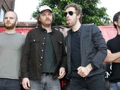 Members of British rock band Coldplay, drummer Will Champion (L), guitarist Jonny Buckland (2nd L), lead singer Chris Martin, and bass guitarist Guy Berryman (R) pose before a news conference in Buenos Aires February 22, 2007. REUTERS/Enrique Marcarian (ARGENTINA)