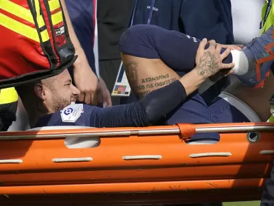 PSG's Neymar is carried off the field on a stretcher after after injuring during the French League One soccer match between Paris Saint-Germain and Lille at the Parc des Princes stadium, in Paris, France, Sunday, Feb. 19, 2023. (AP Photo/Christophe Ena)