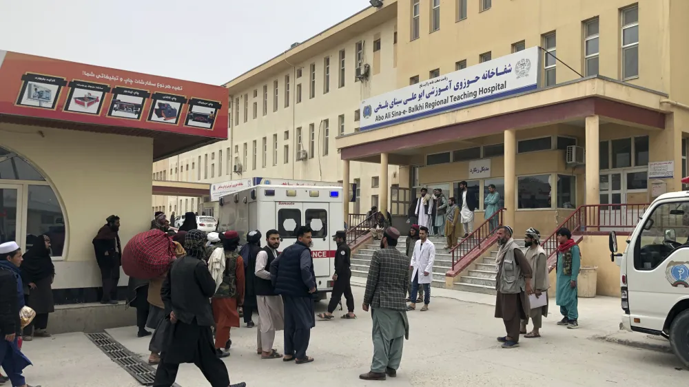 People stand outside a hospital after a bomb blast in Mazar-e Sharif, the capital city of Balkh province, in northern Afghanistan, Thursday, Mar. 9, 2023. A bomb killed a Taliban-appointed provincial governor and two others in Afghanistan's Mazar-e- Sharif Thursday, a Taliban police spokesman said. (AP Photo/Abdul Saboor Sirat)