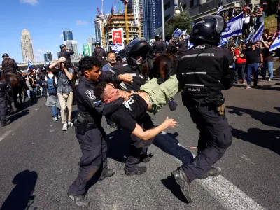 Israeli police officers detain a demonstrator during "Day of Resistance", as Israeli Prime Minister Benjamin Netanyahu's nationalist coalition government presses on with its contentious judicial overhaul, in Tel Aviv, Israel March 9, 2023. REUTERS/Ronen Zvulun   TPX IMAGES OF THE DAY