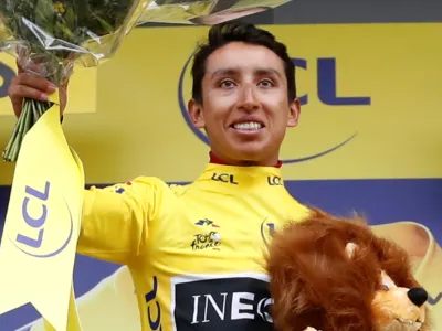 Cycling - Tour de France - The 126.5-km Stage 19 from Saint-Jean-de-Maurienne to Tignes - July 26, 2019 - Team INEOS rider Egan Bernal of Colombia celebrates on the podium, wearing the overall leader's yellow jersey. REUTERS/Christian Hartmann