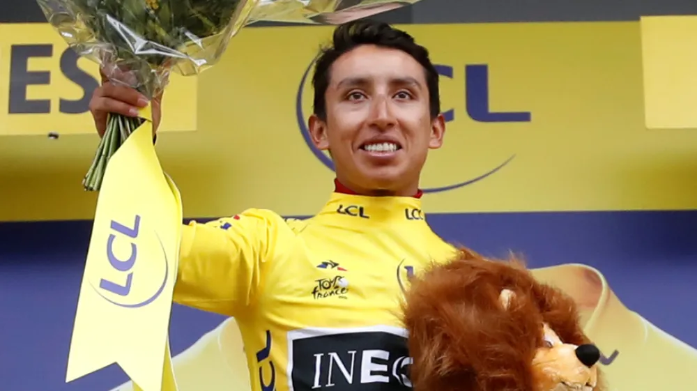 Cycling - Tour de France - The 126.5-km Stage 19 from Saint-Jean-de-Maurienne to Tignes - July 26, 2019 - Team INEOS rider Egan Bernal of Colombia celebrates on the podium, wearing the overall leader's yellow jersey. REUTERS/Christian Hartmann