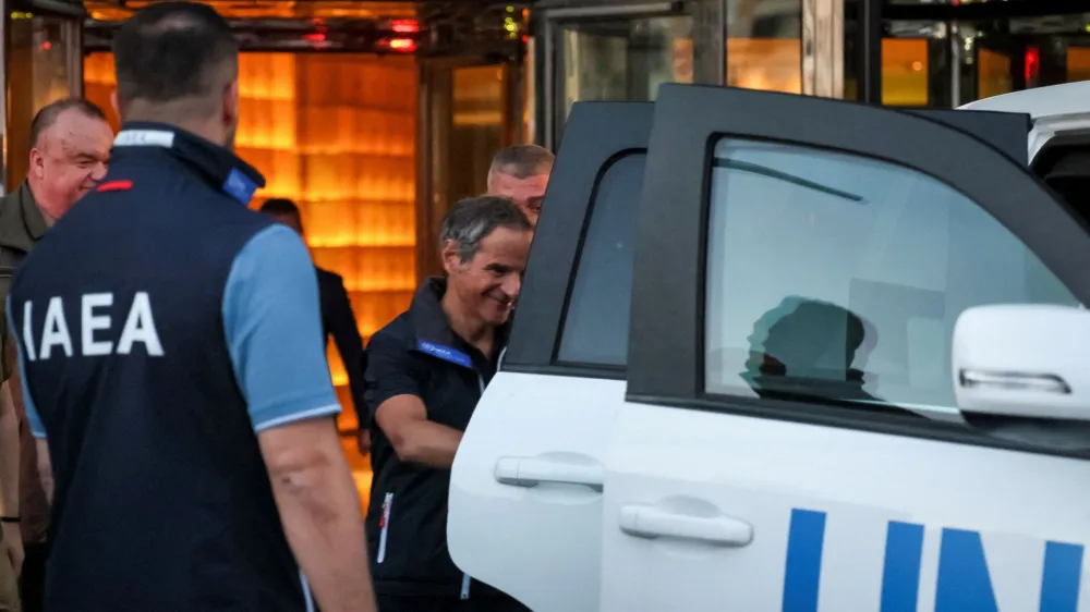 IAEA Director General Rafael Mariano Grossi gets into a UN car before the International Atomic Energy Agency (IAEA) mission departs for visit to Zaporizhzhia nuclear power plant amid Russia's invasion of Ukraine, in central Kyiv, Ukraine August 31, 2022. REUTERS/Gleb Garanich