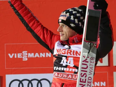 Second placed Dawid Kubacki of Poland celebrates on the podium after the men's HS135 ski jumping competition in Val di Fiemme, Italy, Saturday, Jan. 12, 2019. (Andrea Solero/ANSA via AP)
