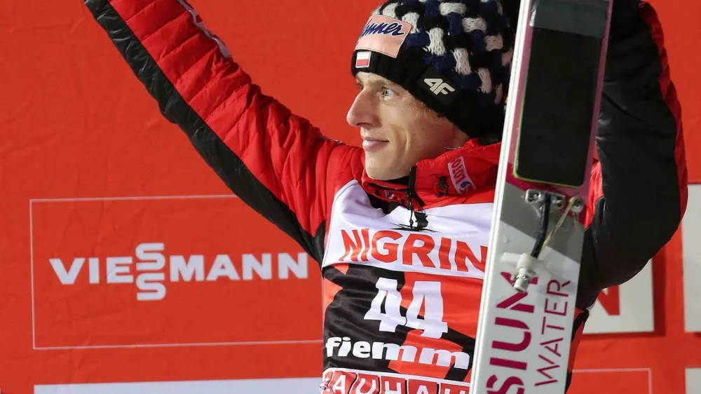 Second placed Dawid Kubacki of Poland celebrates on the podium after the men's HS135 ski jumping competition in Val di Fiemme, Italy, Saturday, Jan. 12, 2019. (Andrea Solero/ANSA via AP)