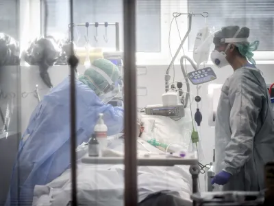 FILE - In this Thursday, March 19, 2020, file photo, medical personnel work in the intensive care unit of a hospital in Brescia, Italy. World War II references are now heard daily, not because another momentous 75th anniversary, Victory in Europe Day approaches in May but because of the coronavirus. (Claudio Furlan/LaPresse via AP, File)