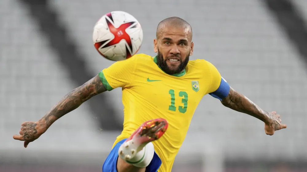 FILE - Brazil's Dani Alves kicks the ball during a men's soccer semifinal match at the 2020 Summer Olympics, Tuesday, Aug. 3, 2021, in Kashima, Japan. Brazilian soccer player Dani Alves has been arrested after being accused of sexually abusing a woman in Barcelona it was reported on Friday, Jan. 20, 2023. Police say the alleged act took place on Dec. 31 at a night club in Barcelona. (AP Photo/Andre Penner, File)