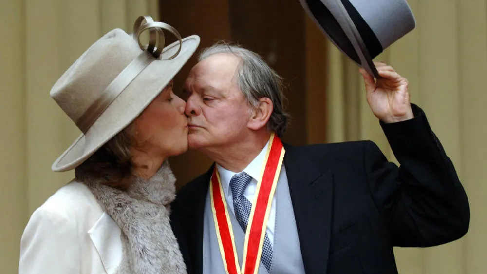 Britain's favourite television actor Sir David Jason and his wife Gill, pose outside Buckingham Palace in London, Thursday Dec. 1, 2005, after receiving his knighthood from Queen Elizabeth II during an investiture ceremony. The couple, who have a daughter, Sophie Mae, aged 4, were married in a secret ceremony in front of 12 guests in London's Dorchester Hotel on Nov. 30.(AP Photo/Fiona Hanson, pool)