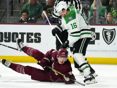 Dallas Stars center Joe Pavelski (16) sends Arizona Coyotes center Barrett Hayton (29) to the ice during the third period of an NHL hockey game Friday, March 31, 2023, in Tempe, Ariz. The Stars won 5-2. (AP Photo/Ross D. Franklin)