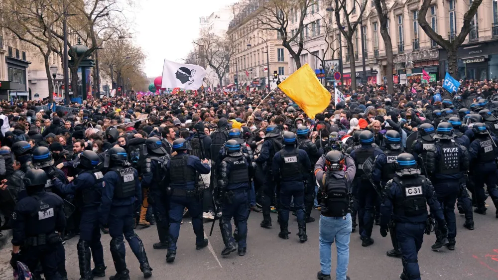 French riot police face off with protesters during a demonstration as part of the ninth day of nationwide strikes and protests against French government's pension reform, in Paris, France, March 23, 2023. REUTERS/Nacho Doce