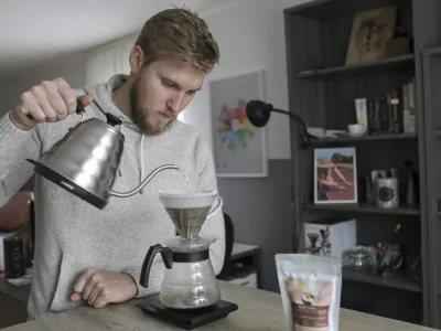 Med pogovorom Žiga Pov&scaron;e pripravi kavo iz zrn kave, ki so jih vzgojili na kmetiji Andressine družine.