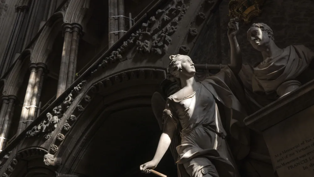 A statue is illuminated by the sun inside Westminster Abbey in London, Wednesday, April 12, 2023, ahead of the King's coronation. Westminster Abbey has been used as Britain's coronation church since William the Conqueror in 1066, with the exception of kings Edward V and Edward VIII, who were not crowned. King Charles III will be the 40th reigning monarch to be crowned there during a ceremony on May 6, 2023. (Dan Kitwood/Pool Photo via AP)