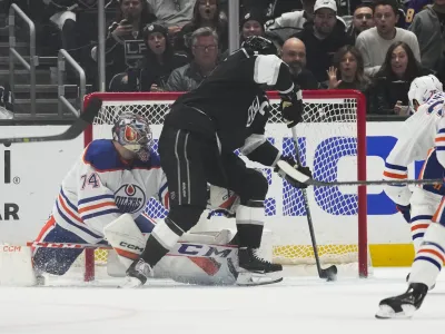 Los Angeles Kings center Anze Kopitar (11) scores against Edmonton Oilers goaltender Stuart Skinner (74) during the first period of Game 4 of an NHL hockey Stanley Cup first-round playoff series hockey game Sunday, April 23, 2023, in Los Angeles. (AP Photo/Ashley Landis)