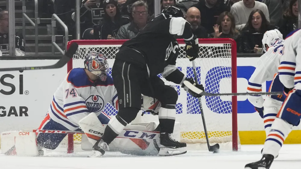 Los Angeles Kings center Anze Kopitar (11) scores against Edmonton Oilers goaltender Stuart Skinner (74) during the first period of Game 4 of an NHL hockey Stanley Cup first-round playoff series hockey game Sunday, April 23, 2023, in Los Angeles. (AP Photo/Ashley Landis)