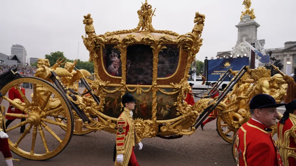 The image of Queen Elizabeth II is seen in a golden carriage during the Platinum Jubilee Pageant outside the Buckingham Palace in London, Sunday, June 5, 2022, on the last of four days of celebrations to mark the Platinum Jubilee. The pageant will be a carnival procession up The Mall featuring giant puppets and celebrities that will depict key moments from the Queen Elizabeth II's seven decades on the throne. (AP Photo/Alberto Pezzali, Pool)