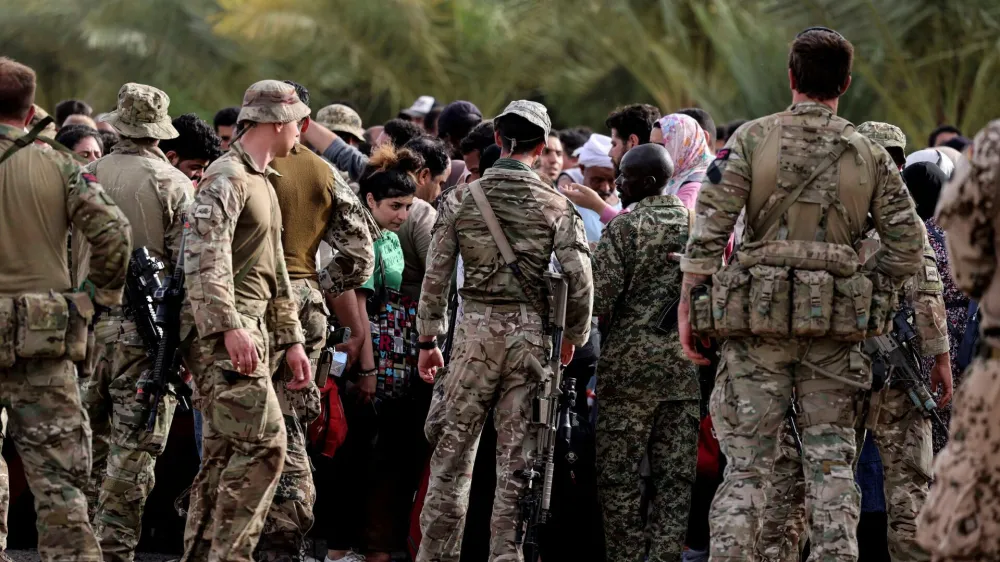 Military personnel gather during the evacuation of British citizens, at Wadi Seidna airport, Sudan April 26, 2023. Arron Hoare/UK MOD/Handout via REUTERS THIS IMAGE HAS BEEN SUPPLIED BY A THIRD PARTY