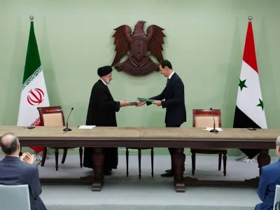 Syria's President Bashar al-Assad and Iranian President Ebrahim Raisi are pictured during the signing of cooperation agreement in Damascus, Syria, in this handout released by SANA on May 3, 2023. SANA/Handout via REUTERS ATTENTION EDITORS - THIS IMAGE WAS PROVIDED BY A THIRD PARTY.
