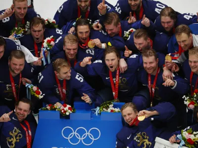2022 Beijing Olympics - Victory Ceremony - Ice Hockey - Men's Gold Medal - National Indoor Stadium, Beijing, China - February 20, 2022. Finland players pose for a picture with their gold medals during the medal ceremony. REUTERS/Brian Snyder