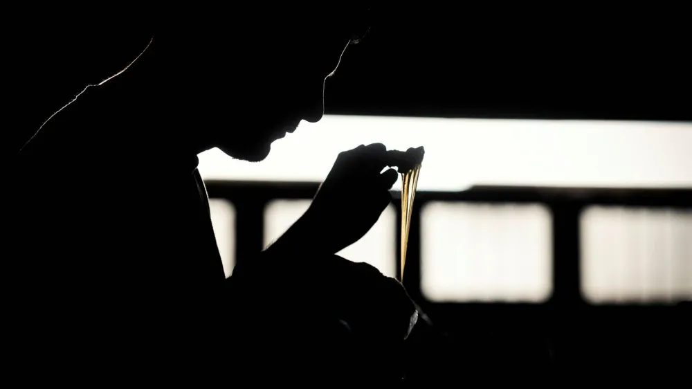 A worker puts glue on shoe soles in a shoe making factory, as small and medium-sized businesses struggle amid rising inflation, on the outskirts of Buenos Aires, Argentina, May 4, 2023. REUTERS/Mariana Nedelcu