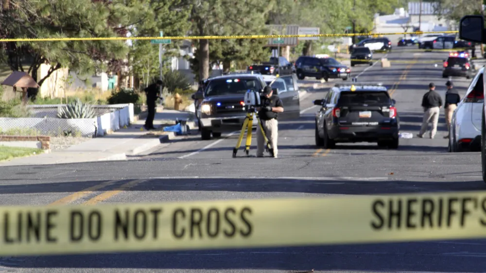 Investigators work along a residential street following a deadly shooting Monday, May 15, 2023, in Farmington, N.M. Authorities said an 18-year-old opened fire in the northwestern New Mexico community, killing multiple people and injuring others, before law enforcement fatally shot the suspect. (AP Photo/Susan Montoya Bryan)