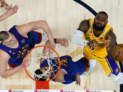 Los Angeles Lakers forward LeBron James (6) loses the ball as Denver Nuggets center Nikola Jokic (15) and Jamal Murray defendduring the second half of Game 1 of the NBA basketball Western Conference Finals series, Tuesday, May 16, 2023, in Denver. The Nuggets defeated the Lakers 132-126. (AP Photo/Jack Dempsey)