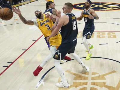 Los Angeles Lakers forward Anthony Davis (3) loses the ball as Denver Nuggets center Nikola Jokic (15) defends during the first half of Game 2 of the NBA basketball Western Conference Finals series, Thursday, May 18, 2023, in Denver. (AP Photo/Jack Dempsey)