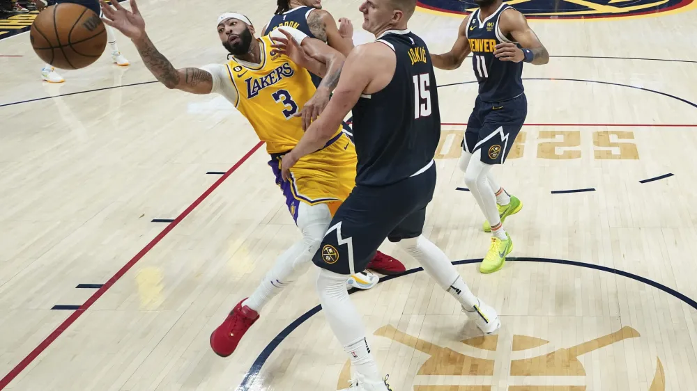 Los Angeles Lakers forward Anthony Davis (3) loses the ball as Denver Nuggets center Nikola Jokic (15) defends during the first half of Game 2 of the NBA basketball Western Conference Finals series, Thursday, May 18, 2023, in Denver. (AP Photo/Jack Dempsey)