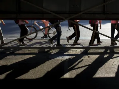 Migrants walk along a street near Belgrade's main bus and train station, in Serbia July 16, 2015. Tens of thousands of migrants from the Middle East and Africa are using the Balkan route to enter the EU, passing from Greece into Macedonia and then Serbia on their way to Hungary, which is in the EU's passport-free Schengen zone. Once there, they can move freely across most internal EU borders. Serbia is not a member of the EU, but more than 34,000 migrants have sought asylum in the former Yugoslav republic so far this year, most of them having crossed from Macedonia and Bulgaria. It is not known how many people in total have entered Serbia illegally.  REUTERS/Marko Djurica