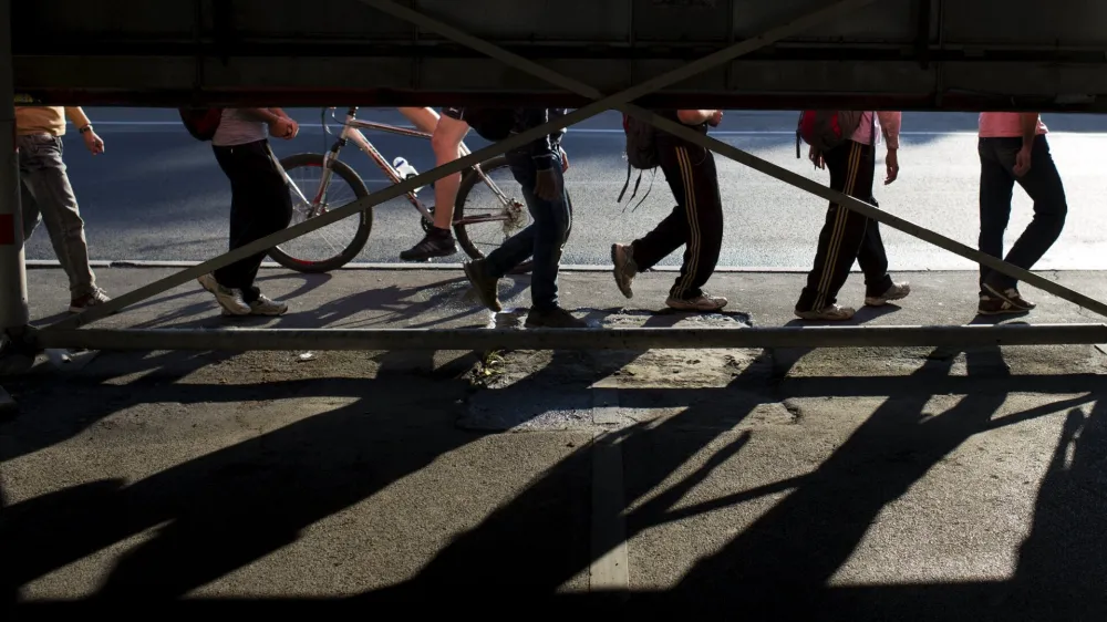 Migrants walk along a street near Belgrade's main bus and train station, in Serbia July 16, 2015. Tens of thousands of migrants from the Middle East and Africa are using the Balkan route to enter the EU, passing from Greece into Macedonia and then Serbia on their way to Hungary, which is in the EU's passport-free Schengen zone. Once there, they can move freely across most internal EU borders. Serbia is not a member of the EU, but more than 34,000 migrants have sought asylum in the former Yugoslav republic so far this year, most of them having crossed from Macedonia and Bulgaria. It is not known how many people in total have entered Serbia illegally.  REUTERS/Marko Djurica