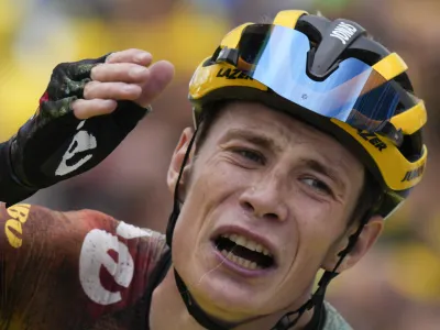 Stage winner and new overall leader Denmark's Jonas Vingegaard celebrates after crossing the finish line of the eleventh stage of the Tour de France cycling race over 152 kilometers (94.4 miles) with start in Albertville and finish in Col du Granon Serre Chevalier, France, Wednesday, July 13, 2022. (AP Photo/Daniel Cole)