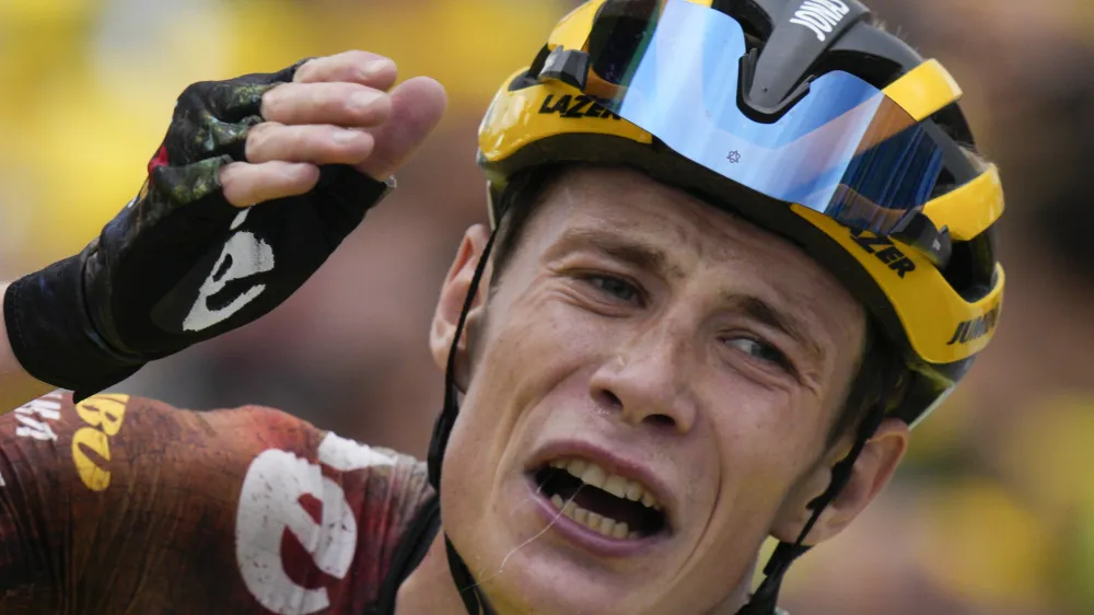 Stage winner and new overall leader Denmark's Jonas Vingegaard celebrates after crossing the finish line of the eleventh stage of the Tour de France cycling race over 152 kilometers (94.4 miles) with start in Albertville and finish in Col du Granon Serre Chevalier, France, Wednesday, July 13, 2022. (AP Photo/Daniel Cole)