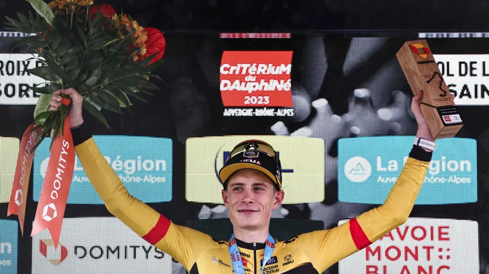 10 June 2023, France, Saint-Sorlin-Darves: Danish cyclist Jonas Vingegaard of UCI WorldTeam Team Jumbo-Visma celebrates on the podium after winning and wearing the yellow jersey of overall leader after the seventh stage of the 75th edition of the Criterium du Dauphine cycling race, 148km between Port de Savoie to Col de la Croix de Fer - Saint Sorlin. Photo: Anne-Christine Poujoulat/AFP/dpa
