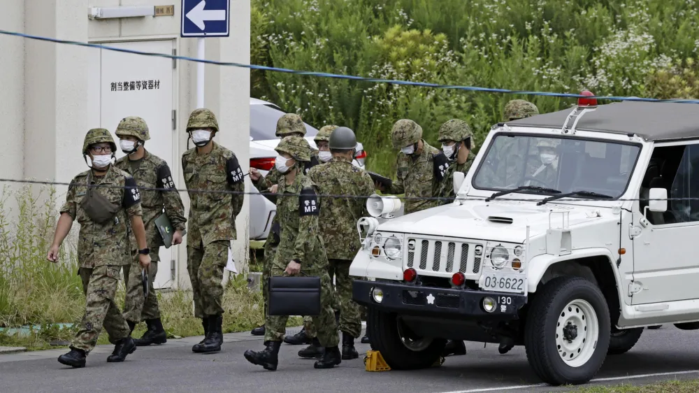 Members of Japan's Self Defense Force gather near a firing range on a Japanese army base following a deadly shooting in Gifu, central Japan, Wednesday, June 14, 2023. An army trainee was arrested Wednesday after allegedly shooting three fellow soldiers at the army base, officials said. (Kyodo News via AP)