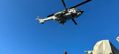 A undated handout photo provided by the Hellenic Coast Guard shows a helicopter during a rescue operation to save migrants onboard a boat, before it capsized at open sea, off Greece. Hellenic Coast Guard/Handout via REUTERS ATTENTION EDITORS - THIS IMAGE HAS BEEN SUPPLIED BY A THIRD PARTY.