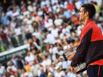 FILED - 11 June 2023, France, Paris: Serbian tennis player Novak Djokovic celebrates with the trophy following his victory over Norwegian Casper Ruud during their men's singles final match of the Roland-Garros Open tennis tournament at the Court Philippe-Chatrier in Paris. Photo: Matthieu Mirville/ZUMA Press Wire/dpa